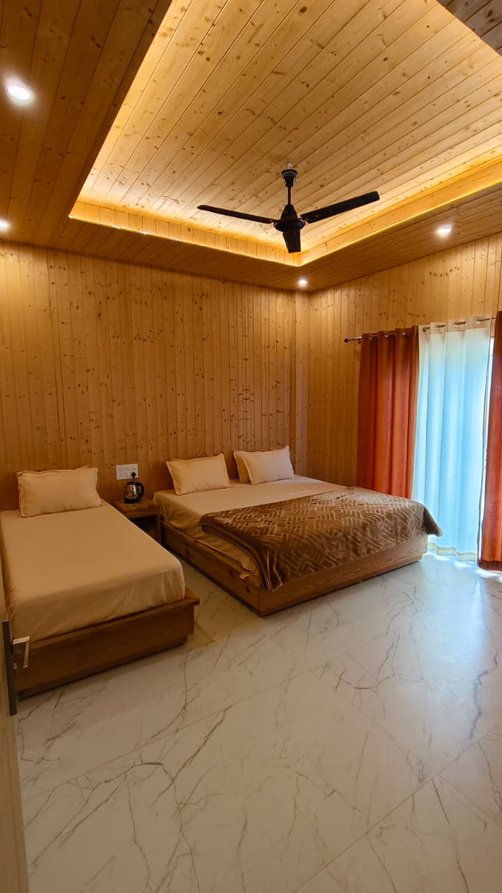 Non-Ganga View Room with lush garden and mountain backdrop at Hotel Dhangauri